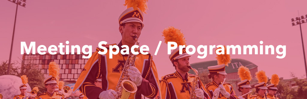 A group of University band performers with the text, "Meeting Space / Programming"